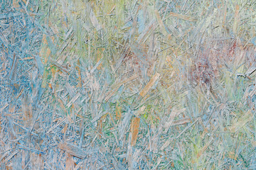 Colorful (green, blue and yellow) painted OSB board as background, texture