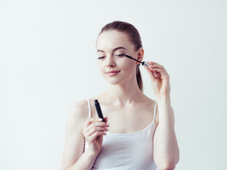 Woman applying mascara, beauty eyes lashes girl makeup 