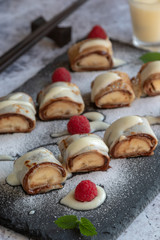 banan pancake sushi dessert with dip and chocolate syrup