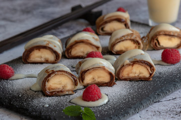 banan pancake sushi dessert with dip and chocolate syrup