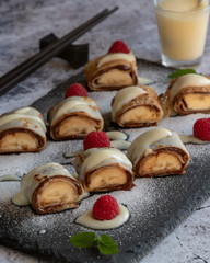 banan pancake sushi dessert with dip and chocolate syrup