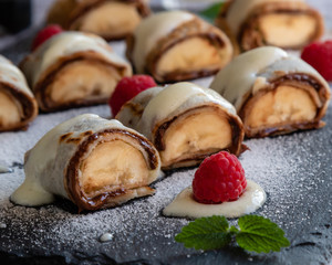 banan pancake sushi dessert with dip and chocolate syrup