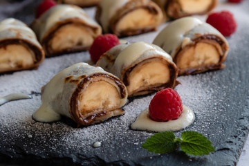 banan pancake sushi dessert with dip and chocolate syrup