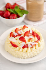Delicate strawberry cheesecake with coconut. Delicious homemade cake with Fresh berries on light table.
