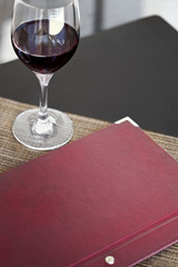 Wine list and glass on a table