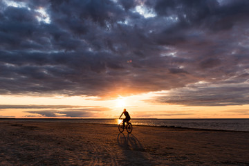 Silhouette of man riding a bicycle