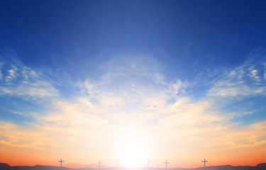 Hope concept: cross of Christ Jesus on sunset sky background
