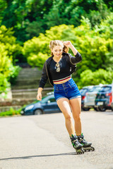 Young woman riding roller skates