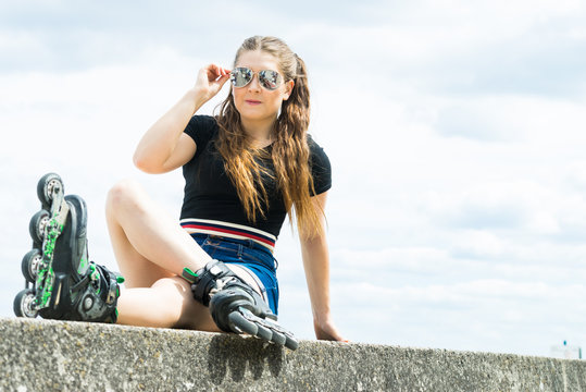 Fit girl with roller skates outdoor