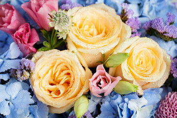 Close up of beautiful soft colour flower bouquet with blue Hydrangea, peach roses, pink lisianthus,...