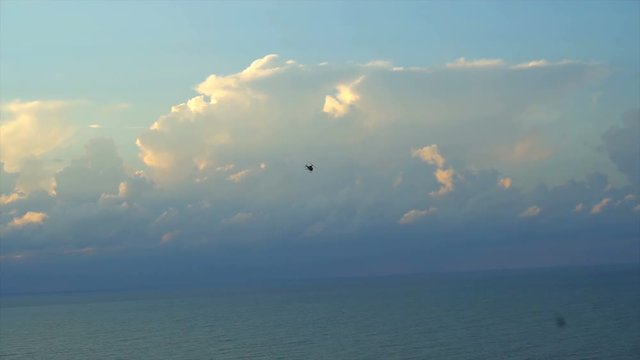 helicopter turns in blue sky 4k