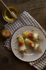 Milky ice cream pops made with fresh figs on a rustic wooden table. Summer lifestyle. Preparing  healthy dessert. Homemade product. Flat lay