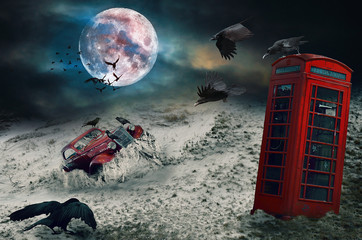 Old car in the sand , red telephone booth, crows, cloudy sky. Photo manipulation.
