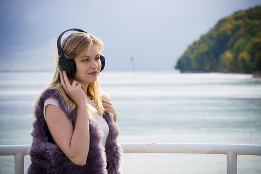 Happy woman wearing headphones outdoor