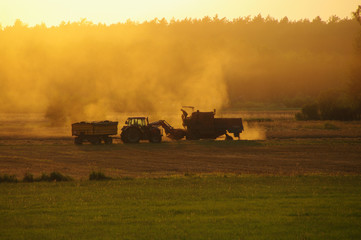 Harvester against hot orange sunset background