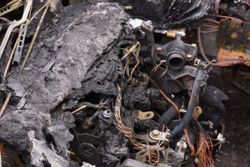 A burned out fire damaged automobile engine ideal for insurance or crime and vandalism concepts