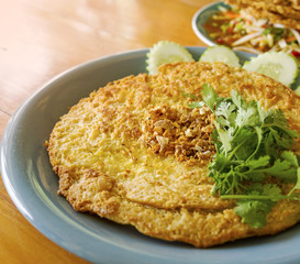 Ostrich’s omelette with fresh parsley in a plate on wood table