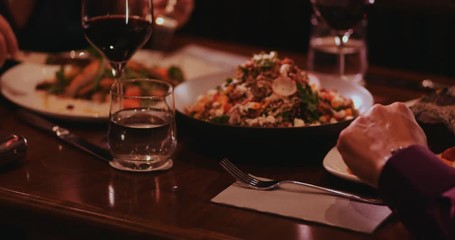 Close-up of people enjoying gourmet dinner at luxurious restaurant