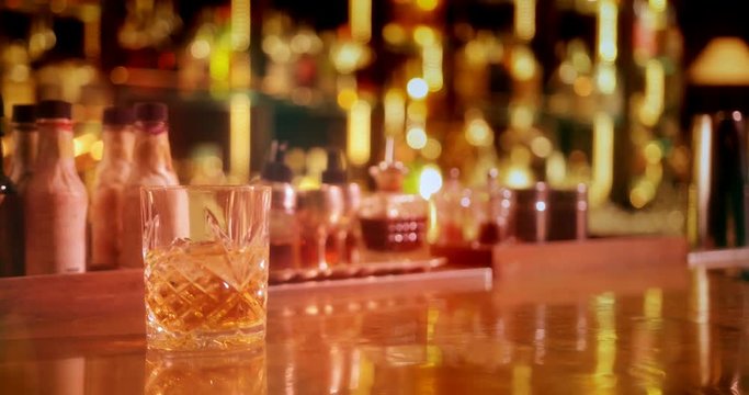 Whiskey with ice served in retro glass on bar counter