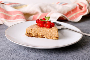 piece of cheesecake with caramel and red currants