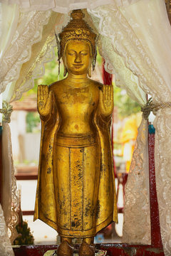 Famous golden Pra Bang statue taken out of the Wat Mai Buddhist temple to demonstrate to public during Lao New Year celebration in Luang Prabang, Laos.