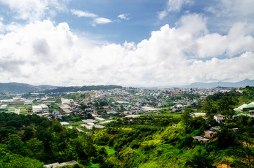 Fototapeta na wymiar Dalat city, Vietnam, View of many houses from hill, The architecture of Dalat, Cityscape, Panorama landscape. a Lat (Dalat) is famous for its wide variety of flowers, vegetables and fruit.