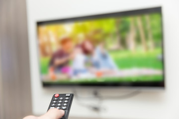people watching tv hand with remote control smart television
