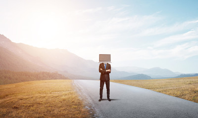 Businessman with laptop instead of head.