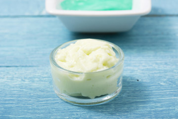 beauty product samples from grape seed ingredient, blue wooden table background, soft light