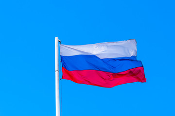 Evolving Russian flag on the background of blue sky