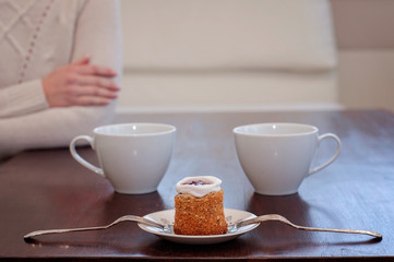Waiting for someone in a caf'e on a table for 2: Runeberg's cake or tart is a Finnish traditional dessert and pastry