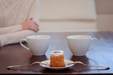 Waiting for someone in a caf'e on a table for 2: Runeberg's cake or tart is a Finnish traditional dessert and pastry