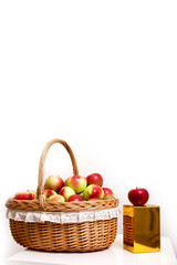 Fototapeta na wymiar red white green apple purse basket background wood table wicker wattled braided lace golden gift box