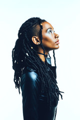 Profile of a woman with long dreadlocks looking up