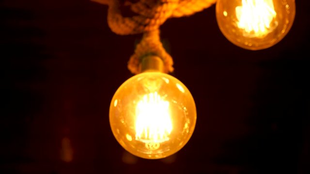Round light bulb against a dark background. Ideea and inspiration