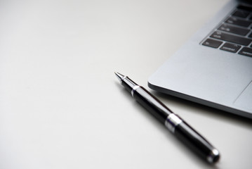 Laptop and pen on the desk, modern businessmen