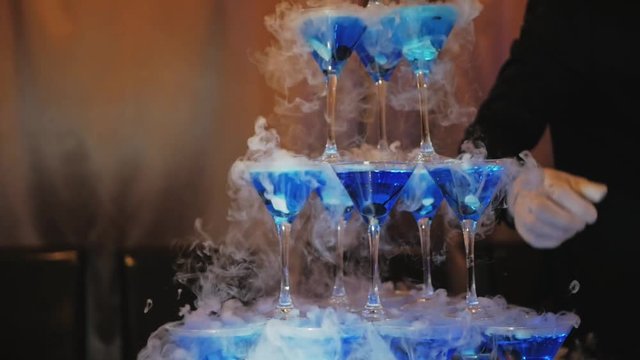 Preparation of cocktails with dry ice. Slow motion video. Clubs of steam from dry ice slowly diverge