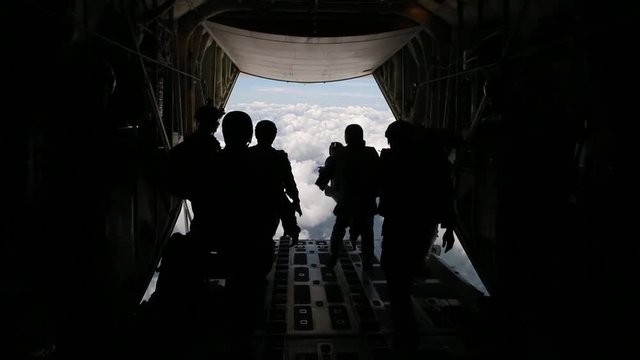 US Army paratroopers jumping from a military plane during special mission