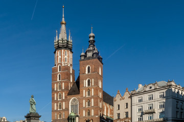 Fototapeta na wymiar The two bell towers of the beautiful Saint Mary's Church in Krakow, Poland on a beautiful sunny day with blue sky