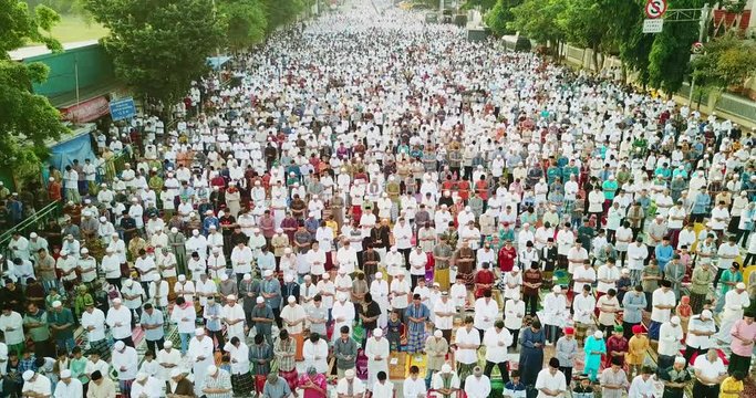 JAKARTA, Indonesia - August 21, 2018: Thousands of muslims people praying together on Eid-ul Fitr day at the street in East Jakarta, Indonesia. Shot in 4k resolution