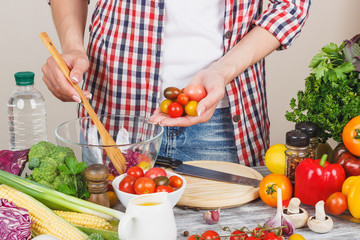 Woman cooks on the kitchen, soft focus background
