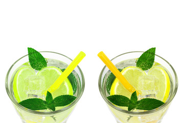 two refreshing drinks with ice, lemon, lime and mint