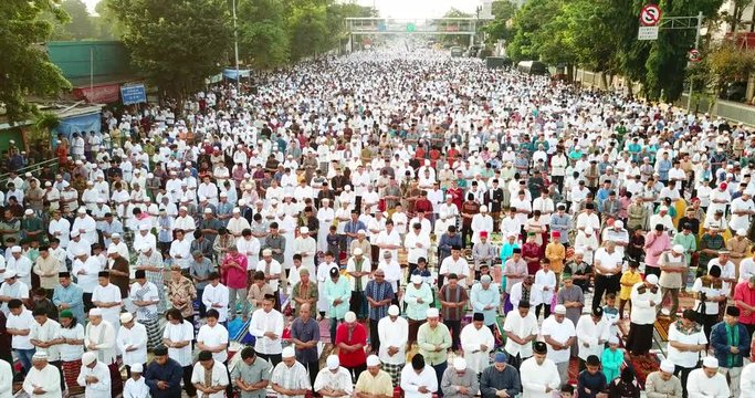 JAKARTA, Indonesia - August 21, 2018: Crowded muslims prayers praying on Eid-ul Fitr day in East Jakarta, Indonesia. Shot in 4k resolution