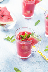Summer drinks from watermelon with mint leaves over a blue table