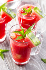 Watermelon drink in glasses with slices of watermelon and mint leaves