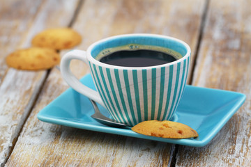 Cup of black coffee in vintage cup with a delicious, crunchy caramel cookie
