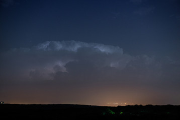 Naklejka na ściany i meble Thunderstorm clouds at night with lightning