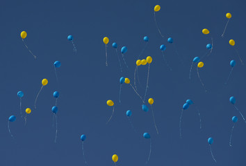 Yellow and blue balloons fly in Ukrainian sky