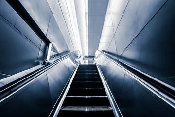 Escalator in the city leading to the underground passage of the subway