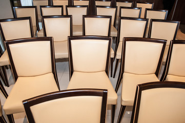 holiday concept, luxurious wooden chairs with beige upholstery are in the assembly hall